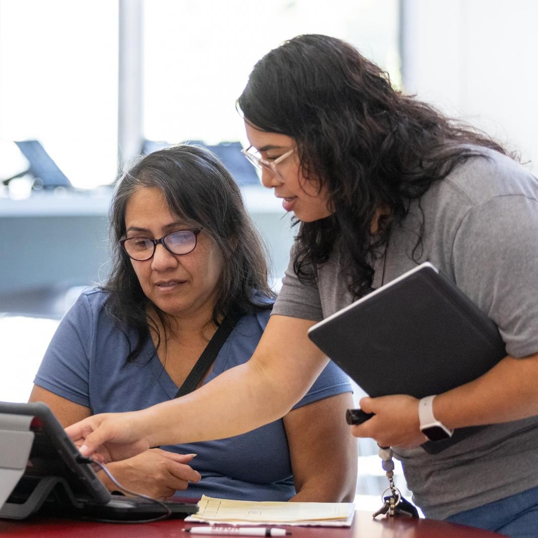  A staff member works with a family to register for school